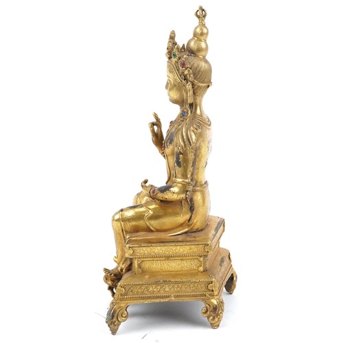 105 - Chino Tibetan jewelled gilt bronze figure of seated Buddha, 24cm high