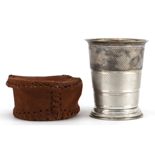 488 - German 800 grade hunting interest engine turned silver collapsible stirrup cup with suede case, with... 