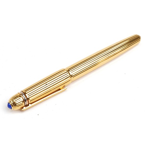 128 - Cartier Pasha gold plated fountain pen set with a blue cabochon having an 18k gold nib dated 1989, s... 