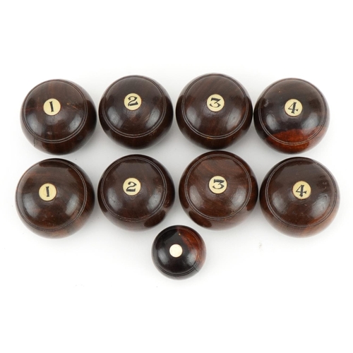 93 - Set of eight lignum vitae bowls with marker, each bowl approximately 4.5cm in diameter