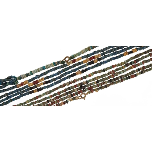 162 - Two ancient Egyptian faience four strand bead necklaces, the largest 64cm in length