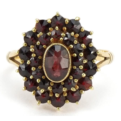 2253 - 18ct gold Bohemian garnet three tier cluster ring with split shoulders, the largest garnet approxima... 