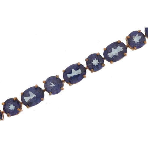 2006 - 9ct gold topaz line bracelet, the largest stones approximately 8.0mm x 6.0mm, 20cm in length, 11.7g