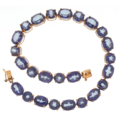 2006 - 9ct gold topaz line bracelet, the largest stones approximately 8.0mm x 6.0mm, 20cm in length, 11.7g