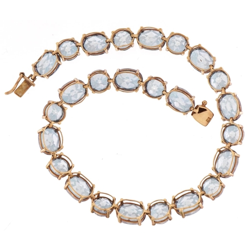 2006 - 9ct gold topaz line bracelet, the largest stones approximately 8.0mm x 6.0mm, 20cm in length, 11.7g