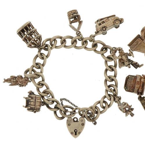 2266 - Two silver charm bracelets with love heart padlocks and a selection of mostly silver charms includin... 