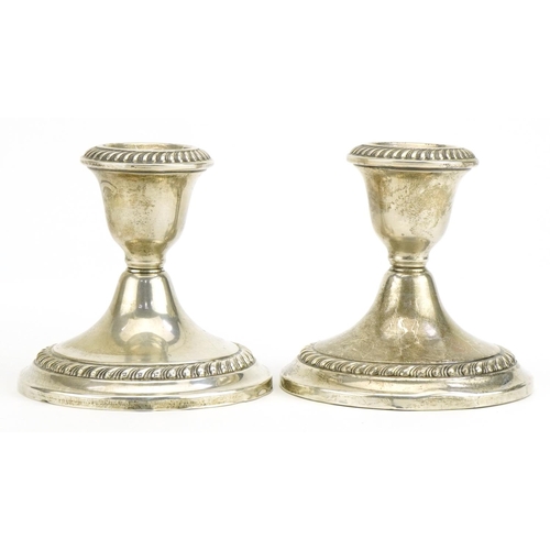 530 - Gorham, Pair of American sterling silver dwarf candlesticks with embossed decoration, 9cm high, tota... 