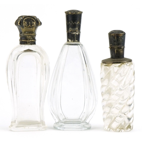 489 - Three Dutch silver mounted glass scent bottles including two cut glass examples, the lids with engra... 