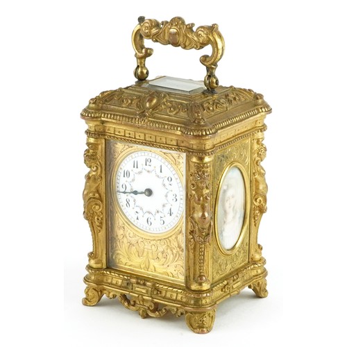 Francois Arsene Margaine, 19th century French miniature brass carriage clock with key, painted portrait panels, gilt foliate face and enamelled dial having Roman numerals, the back plate and key numbered 12219, 8cm high excluding the swing handle
