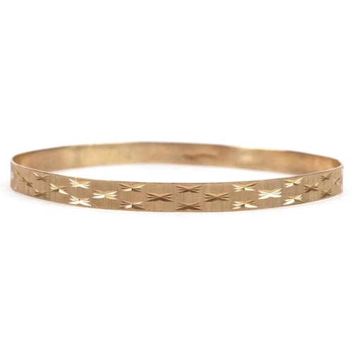 5 - 9ct gold engine turned bangle, 7cm in diameter, 6.8g