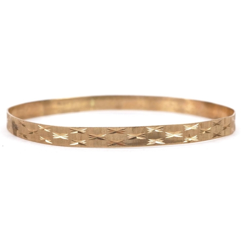 5 - 9ct gold engine turned bangle, 7cm in diameter, 6.8g