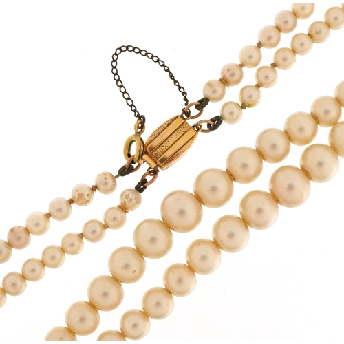 65 - Two strand graduated simulated pearl necklace with 9ct gold clasp, 44cm in length, 36.5g