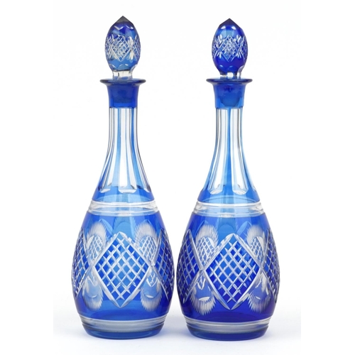 122 - Pair of Bohemian blue overlaid cut glass decanters, each 36cm high