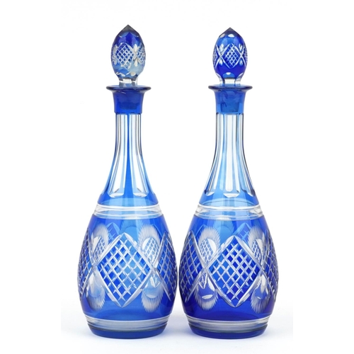 122 - Pair of Bohemian blue overlaid cut glass decanters, each 36cm high