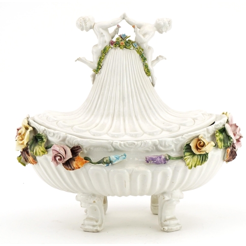 125 - **WITHDRAWN** Italian floral encrusted porcelain four footed centre bowl and cover with Putti finial... 