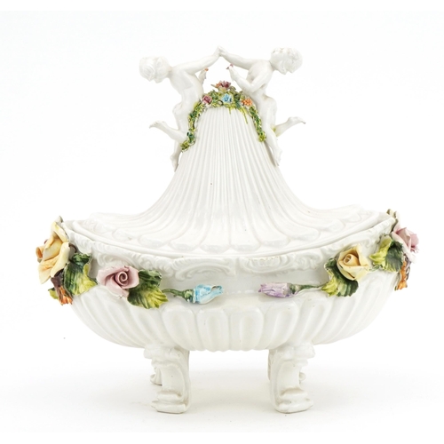 125 - **WITHDRAWN** Italian floral encrusted porcelain four footed centre bowl and cover with Putti finial... 