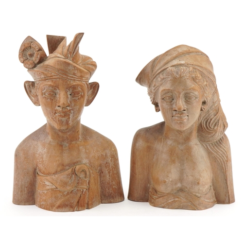 128 - Two Balinese carved wood busts, the largest 24cm high