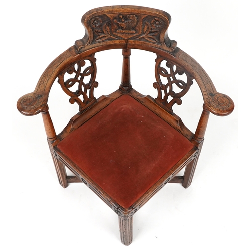 50 - 19th century country style corner chair carved with lion crest and flowers, 80cm high