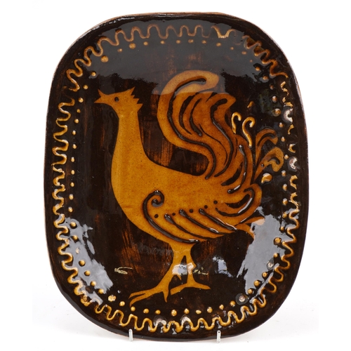 2310 - Slipware style dish hand painted with a stylised bird, 32cm in length