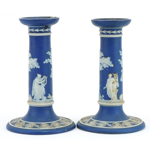 169 - Pair of Wedgwood Jasperware candlesticks decorated in relief with classical figures, each 17cm high