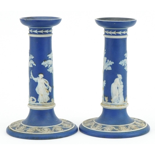 169 - Pair of Wedgwood Jasperware candlesticks decorated in relief with classical figures, each 17cm high