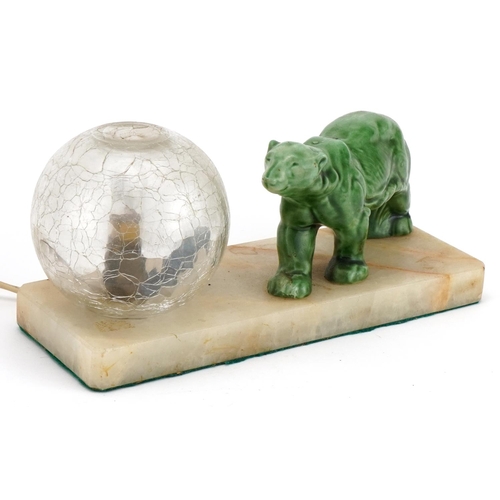 105 - Art Deco onyx table lamp with globular glass shade surmounted with a polar bear, 25cm wide