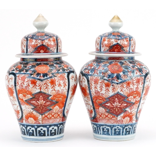 481 - Pair of Japanese Imari porcelain vases and covers hand painted with flowers, each 28cm high