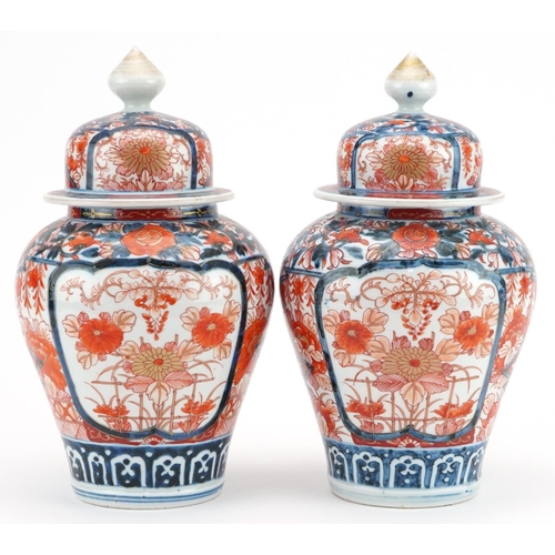 481 - Pair of Japanese Imari porcelain vases and covers hand painted with flowers, each 28cm high