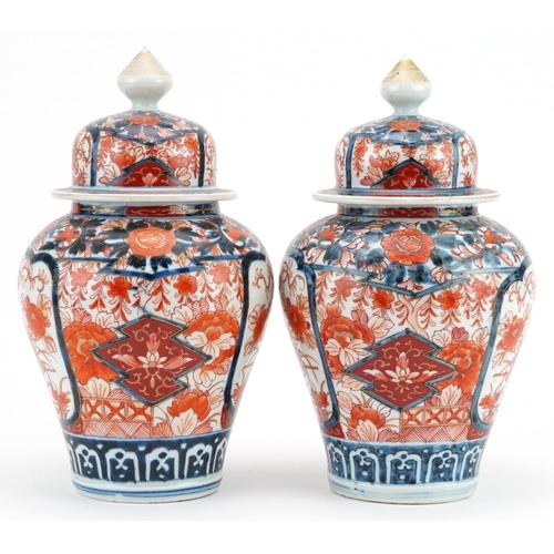 481 - Pair of Japanese Imari porcelain vases and covers hand painted with flowers, each 28cm high