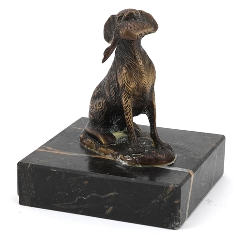 2312 - Patinated bronze seated gun dog with game raised on a square marble base, 17.5cm high