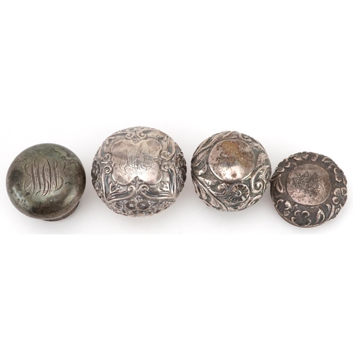 128 - Four silver scent bottle tops including floral examples, various hallmarks including London, the lar... 