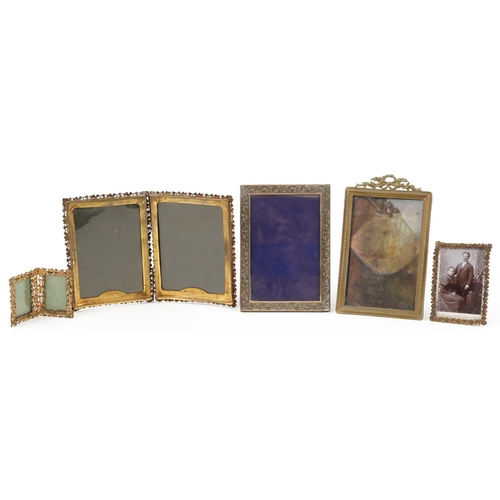 301 - Five vintage brass floral photo frames including clover folding examples, the largest 9cm high