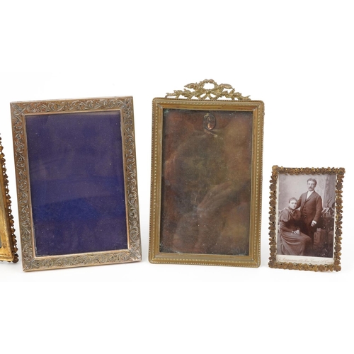 301 - Five vintage brass floral photo frames including clover folding examples, the largest 9cm high