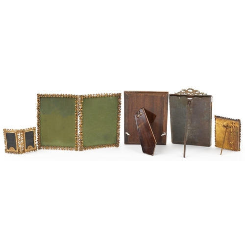 301 - Five vintage brass floral photo frames including clover folding examples, the largest 9cm high