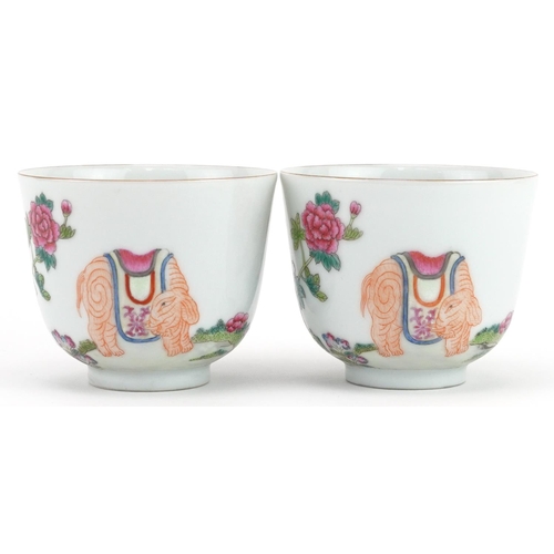 406 - Pair of Chinese porcelain tea bowls hand painted in the famille rose palette with elephants in a lan... 