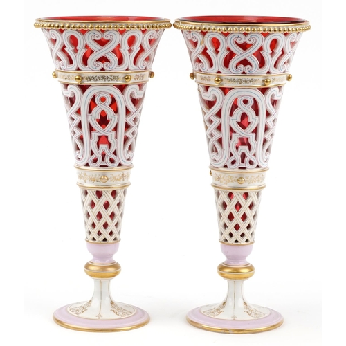 278 - Pair of 19th century continental porcelain pierced vases with gilt foliate decoration and cranberry ... 
