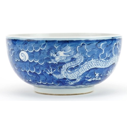 109 - Chinese blue and white porcelain bowl hand painted with dragons chasing the flaming pearl amongst cl... 