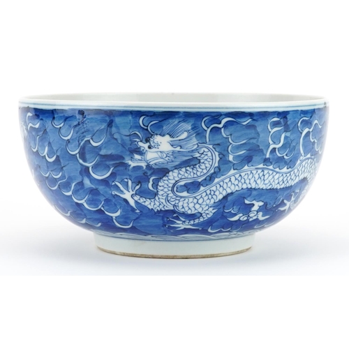 109 - Chinese blue and white porcelain bowl hand painted with dragons chasing the flaming pearl amongst cl... 