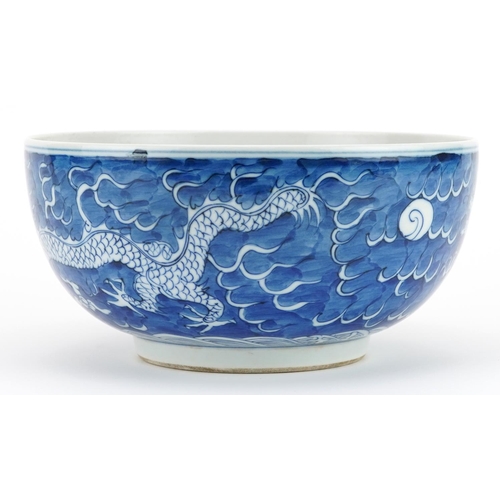 109 - Chinese blue and white porcelain bowl hand painted with dragons chasing the flaming pearl amongst cl... 