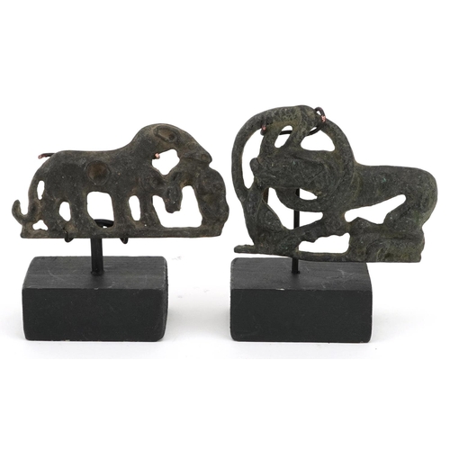 389 - Two Persian Luristan patinated mythical animal bronzes including a buckle, each raised on stands, th... 