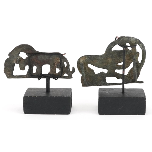 389 - Two Persian Luristan patinated mythical animal bronzes including a buckle, each raised on stands, th... 