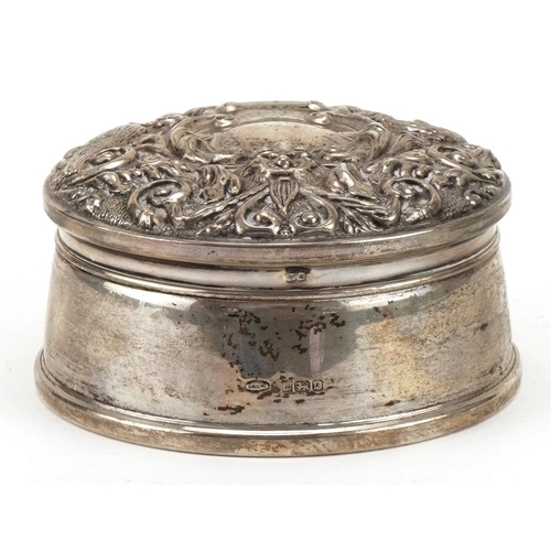 305 - W I Broadway & Co, Elizabeth II circular silver jewel box, the hinged lid embossed with birds amongs... 