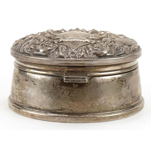 305 - W I Broadway & Co, Elizabeth II circular silver jewel box, the hinged lid embossed with birds amongs... 