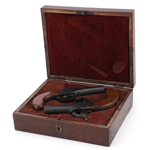 2513 - Pair of 19th century percussion muff pistols with engraved plates, housed in a fitted velvet lined b... 