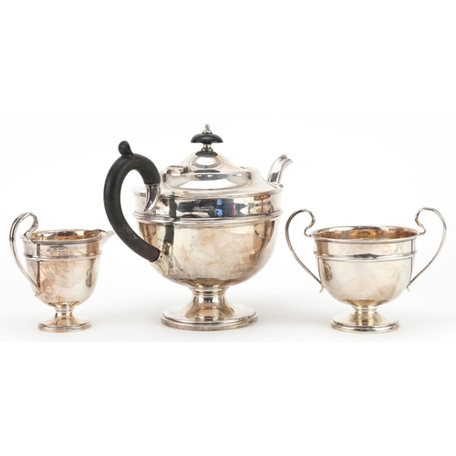 268 - Viners, George V silver three piece tea service, the teapot with ebonised handle and knop, Sheffield... 