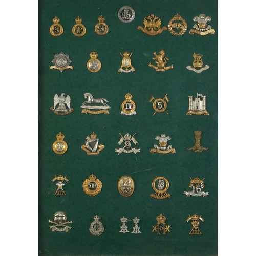 2412 - Military interest cap badges arranged in a glazed display including 14th King's Hussars, 16th The Qu... 