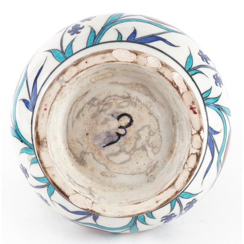 85 - Turkish Ottoman Iznik pottery handled vessel hand painted with stylised flowers, 25cm high