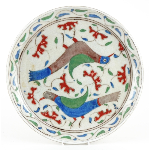 154 - Turkish Ottoman Iznik pottery plate hand painted with two stylised birds amongst flowers, 30cm in di... 