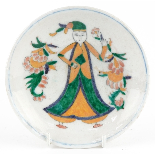 155 - Turkish Ottoman Iznik pottery footed plate hand painted with a figure in traditional dress amongst f... 