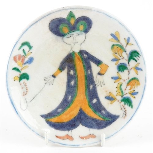 156 - Turkish Ottoman Iznik pottery footed plate hand painted with a figure in traditional dress amongst f... 